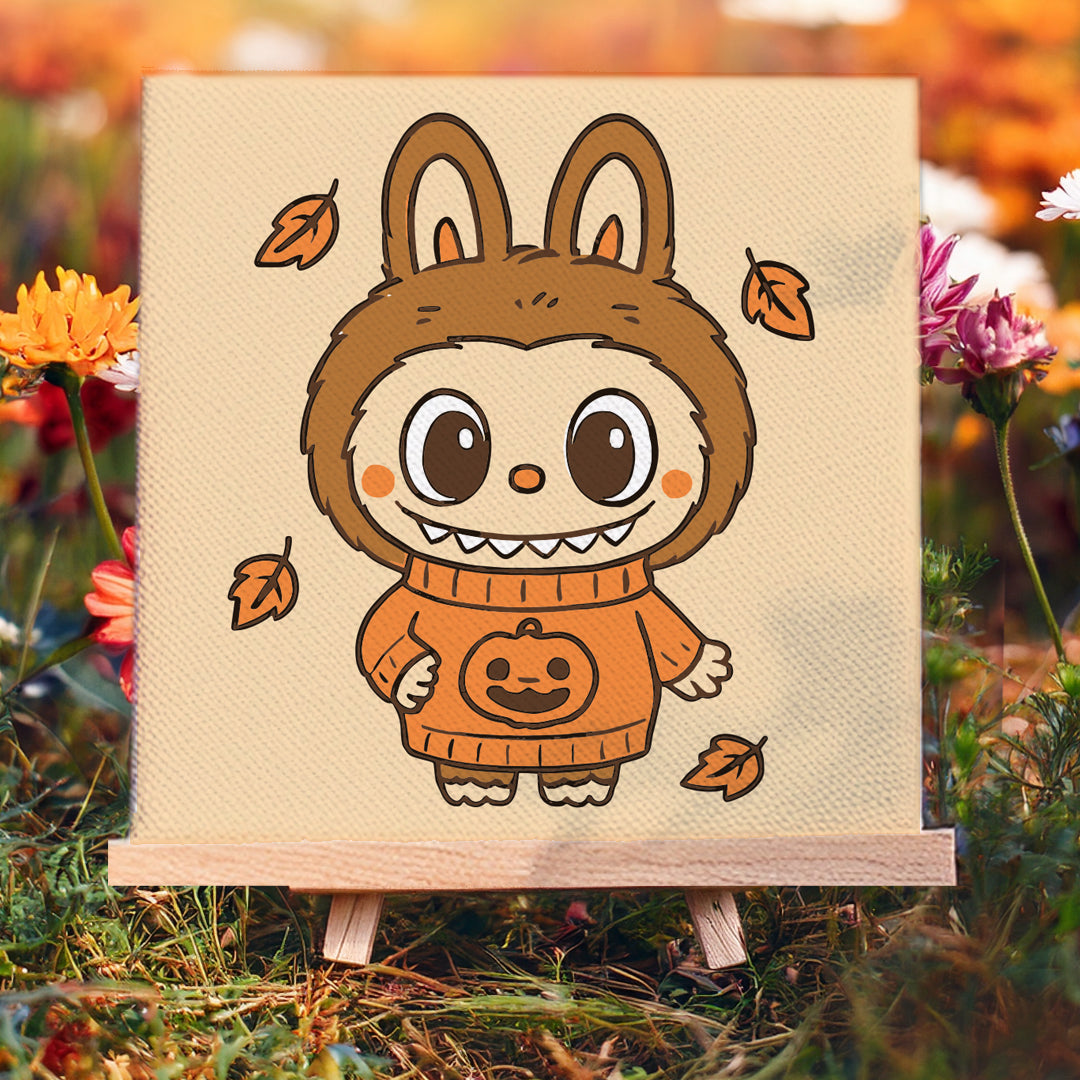Painting kit of Labubu in a Halloween costume on a wooden easel with autumn leaves and flowers in the background.