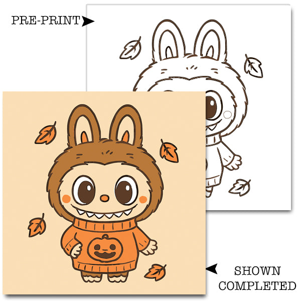 Labubu in a Halloween costume with leaves on a beige background, showing pre-print and completed versions.